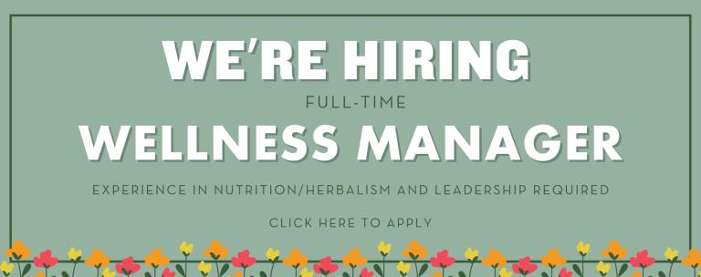 We're Hiring! Full Time Wellness Manager with experience in leadership, nutrition and herbalism. Click to apply online! Written in white text on green background with small red and yellow tulips lining the bottom